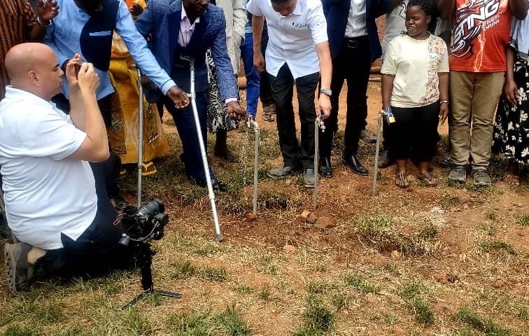 Community members and guests open new water taps at KPDDI's compound in Kireka