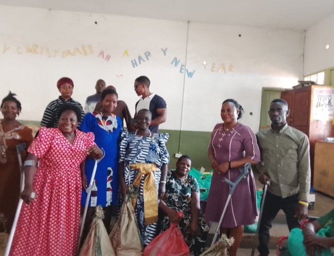 KPDDI members gathered in the hall with food parcels and support packages